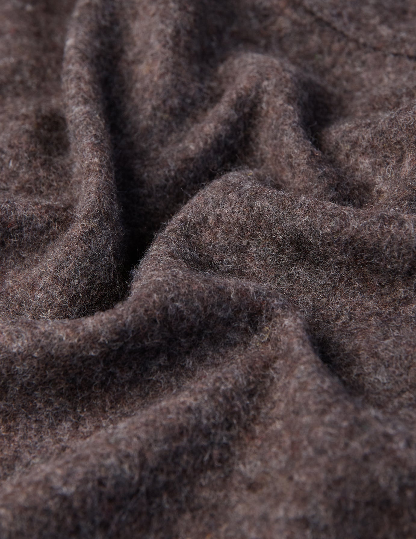 Close-up of the Double Layer Wool Overshirt Saddle Brown featuring brown textured fabric with soft folds.